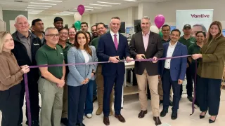 Group of Vantive employees and guests gathered for a ribbon-cutting ceremony inside the Central Service Hub.