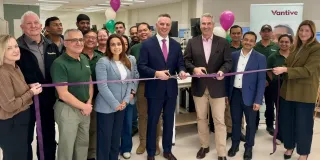 Group of Vantive employees and guests gathered for a ribbon-cutting ceremony inside the Central Service Hub.