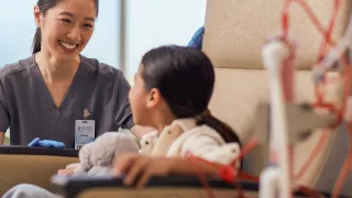 Female healthcare professional giving treatment to child