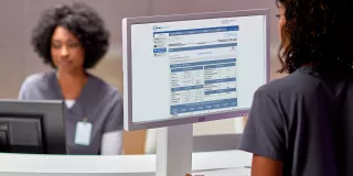 Woman on laptop viewing Sharesource remote patient management