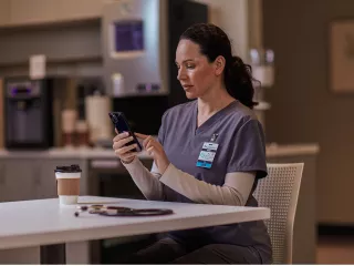 Healthcare professional sitting at table on phone