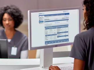 Woman on laptop viewing Sharesource remote patient management